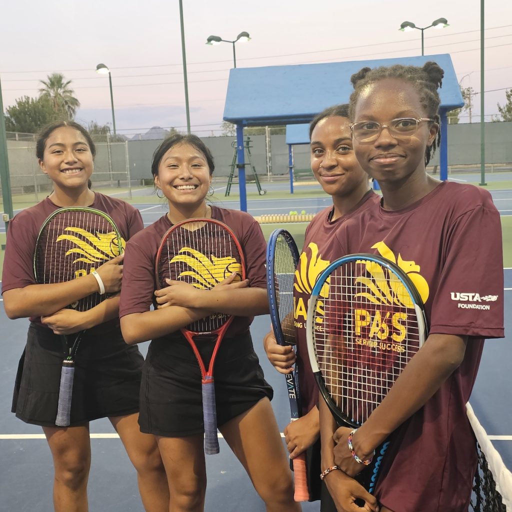 Photo of four female kids at the Pass Kids tennis event.